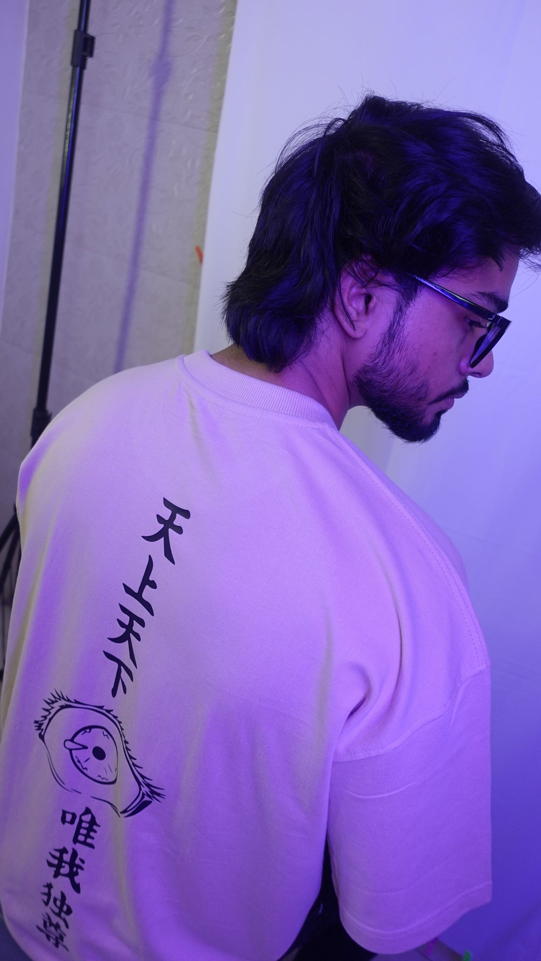 Model showcasing back of Gojo Satoru oversized tshirt from Badgers